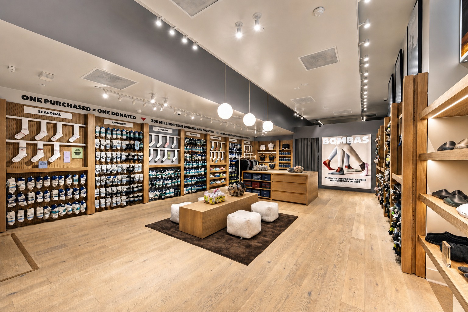 Completed Bombas flagship salesfloor with oak millwork and globe pendants