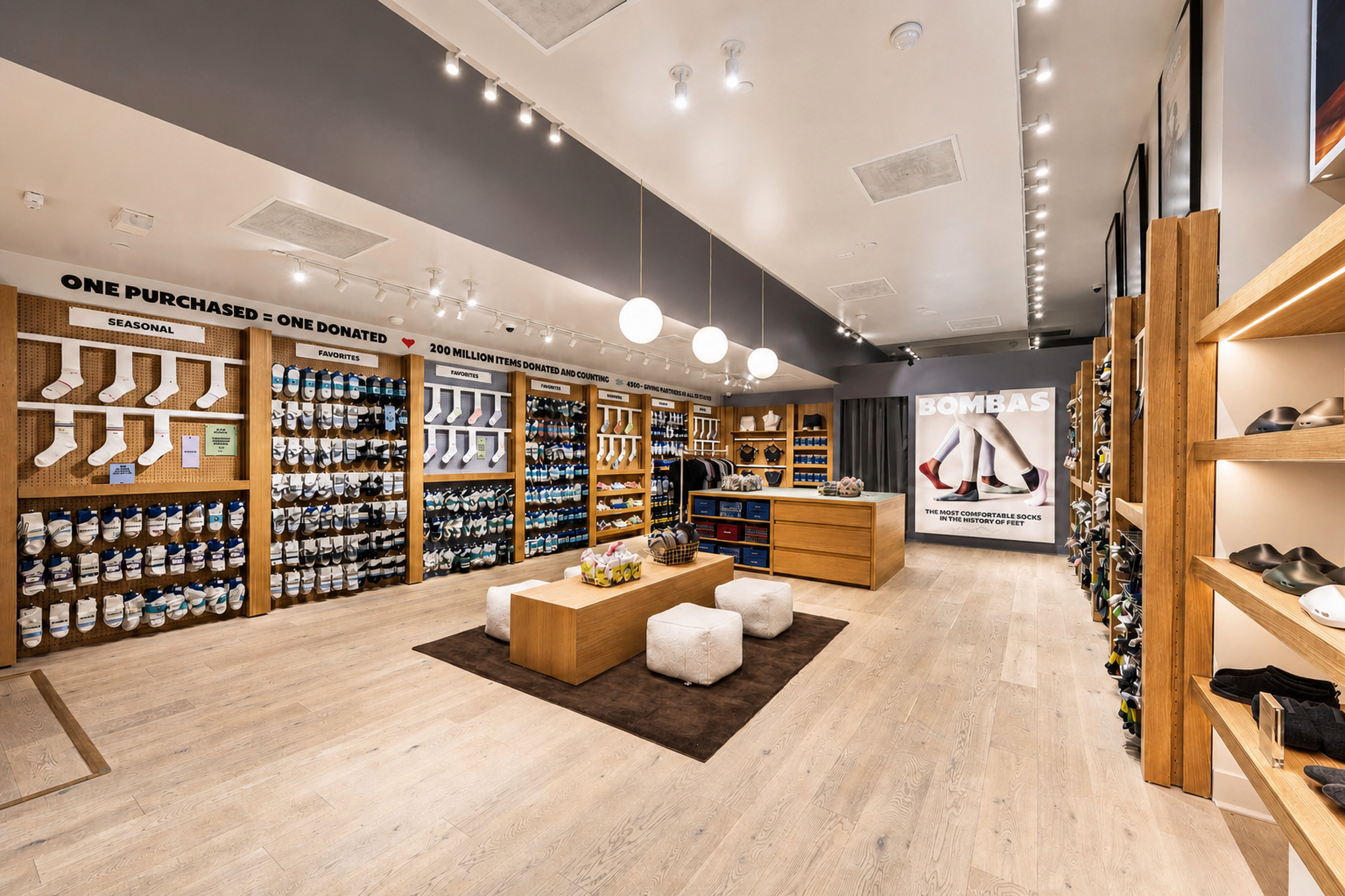 Completed Bombas store buildout with oak millwork and product walls